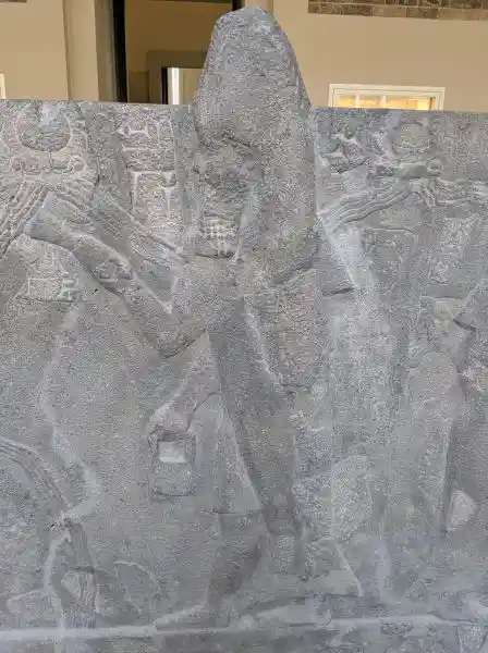 Detail of the reconstruction of basalt water basin, a man in fish clothes (facing left), located in Pergamon museum.